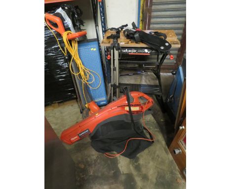 A SELECTION OF SIX ITEMS TO INCLUDE A BLACK &amp; DECKER WORKMATE, A FLYMO LEAF VAC, A FLYMO STRIMMER, A GUILLOTINE, A CAMERA