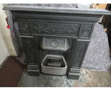 A VINTAGE CAST IRON FIRE SURROUND AND GRATE