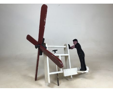 A wooden folk art style windmill automaton. Approx W:50cm x H:50cm