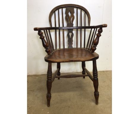 A Victorian smokers bow stick back arm chair with elm seat. W:59cm x D:55cm x H:93cm