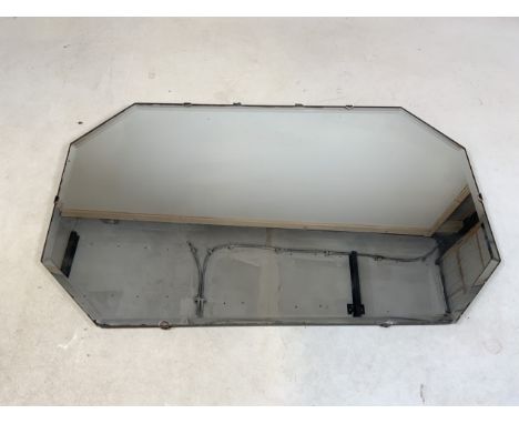 An Art Deco mirror with bevelled edge and wooden back 