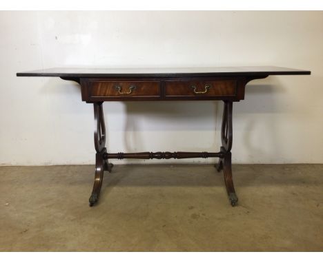 An early 20th century mahogany sofa table with double drawer and brass handles, brass lion feet and castors. W:92cm x D:56cm 