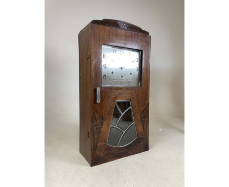 A French Vedette clock C.1920. With carved details to front and Art Deco window with bevelled glass panels.W:35cm x D:18cm x 