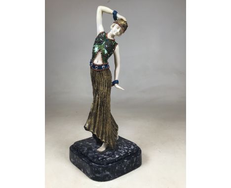 A reproduction Art Deco figurine on faux marble plinth. H:39cm