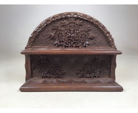 A highly detailed delicately carved pipe rack. W:31cm x D:8cm x H:24cm