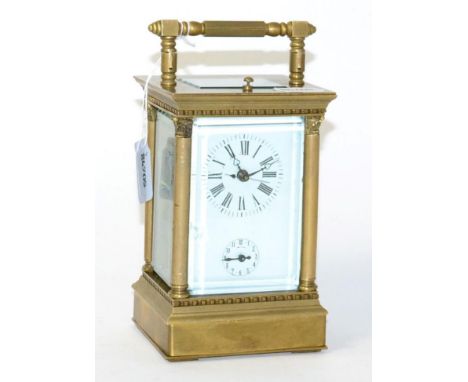 A reproduction brass striking and repeating alarm centre seconds carriage clock 