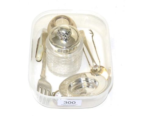 A silver small pin tray, silver mounted match striker, silver mounted glass bottle, silver wristwatch, mother of pearl pen kn