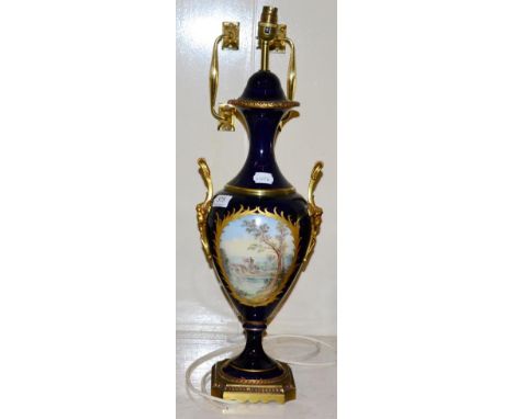 A modern Sevres style table lamp in cobalt blue with gilt highlights, depicting an amorous couple, height 62cm