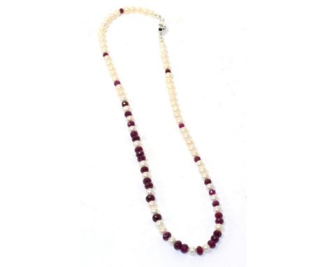 A cultured pearl and faceted ruby bead necklace with ruby set clasp, 54cm long 