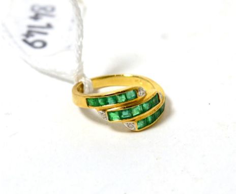 An emerald and diamond ring, three bands of step cut emeralds in yellow channel settings, each band terminating with a round 