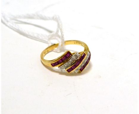 A ruby and diamond ring, three diagonal bands of step cut rubies in yellow channel settings, spaced by bands of pavé set roun