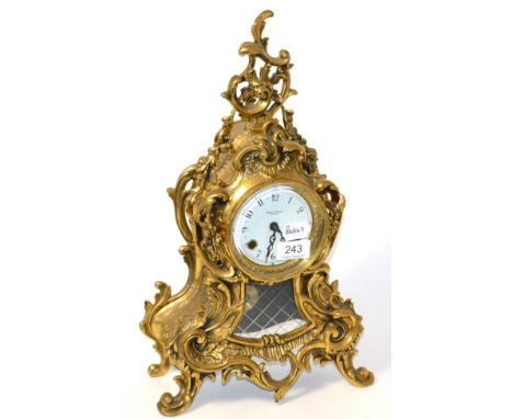 A reproduction gilt metal striking mantel clock, movement stamped Franz Hermle, made in Germany, dial marked by retailer Robe