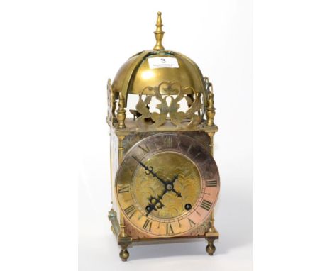 A brass lantern type striking mantel clock, chapter ring signed by retailer Rattray & Co, Dundee 