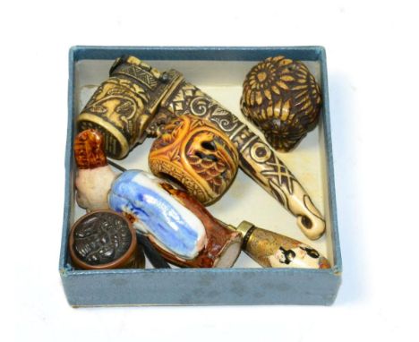 Six Japanese curiosities comprising pottery netsuke, two ojime, scribe's pen case, satsuma hat pin and one other 