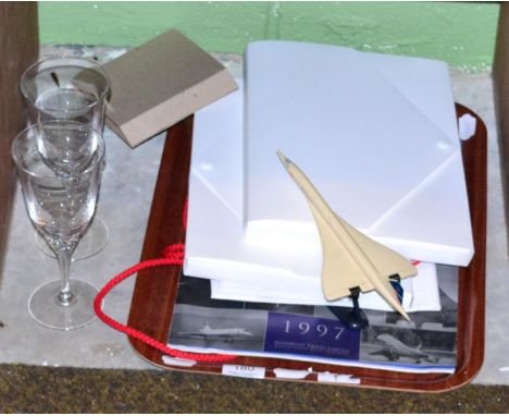 Concorde memorabilia including two gift packs containing menu, postcard, certificates and others; two glasses, a plastic bag 