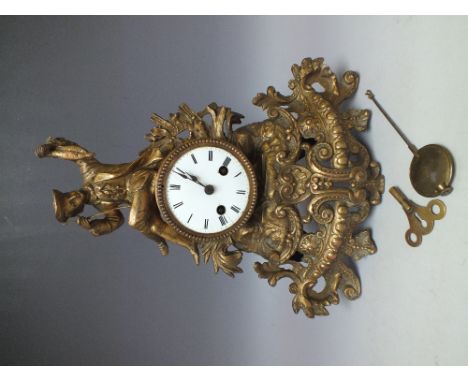A FRENCH GILT CAST METAL DECORATIVE MANTLE CLOCK, the circular enamel dial with Roman numerals and outer minute track, the 8 