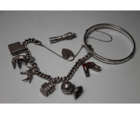 A HALLMARKED SILVER CHARM BRACELET WITH ATTACHED CHARMS, the bracelet stamped to individual links, hallmarked heart shaped cl