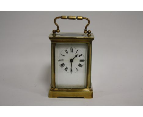 A SMALL BRASS CASED DUVERDREY &amp; BLOQUEL CARRIAGE CLOCK, the enamel dial with Roman numerals, the movement with lion backs