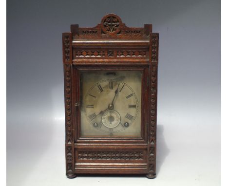 A LATE 19TH / EARLY 20TH CENTURY WINTERHALDER &amp; HOFMEIER CARVED OAK CASED MANTEL CLOCK, silvered dial with Roman numerals