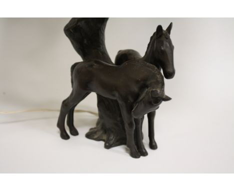 A BRONZED TABLE LAMP IN THE FORM OF TWO FOALS BY A TREE TRUNK, marked Foreign to base, H 37 cm to top of fitment