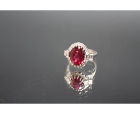 AN 18CT WHITE GOLD ART DECO STYLE  DIAMOND AND RUBY TYPE RING, the central red stone measuring approx 11mm x 8mm, ring size G