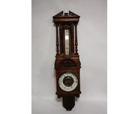 AN EDWARDIAN OAK CARVED ANEROID BAROMETER, H 103 cm