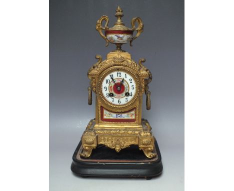 A LATE 19TH CENTURY CONTINENTAL PORCELAIN AND GILT SPELTER CLOCK, the case surmounted with twin handled urn, having painted e