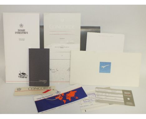 A FOLDER OF VARIOUS CONCORDE MEMORABILIA, to include flight information booklet, flight certificate, flight entertainment pro