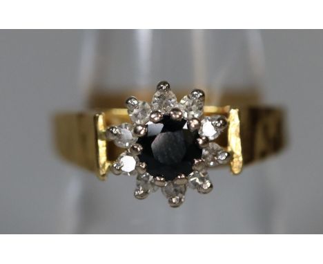 18ct gold sapphire and diamond cluster ring.  Ring size N.  Approx weight 5.6 grams.(B.P. 21% + VAT) 