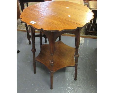 Early 20th Century oak lamp or occasional table, the carved top above turned legs and under-tier, made for Liberty and Co. Lo