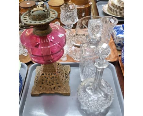 Tray containing two cut glass decanters and stoppers, one square, the other baluster shaped, together with an oil lamp with c