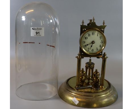 Early 20th Century brass perpetual motion clock, architectural design, with key and glass dome. (B.P. 21% + VAT) 
