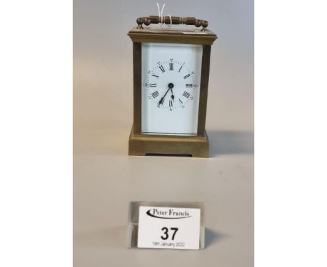 French style brass carriage clock with full depth Roman enamel face and with key.(B.P. 21% + VAT) The case is tarnished overa