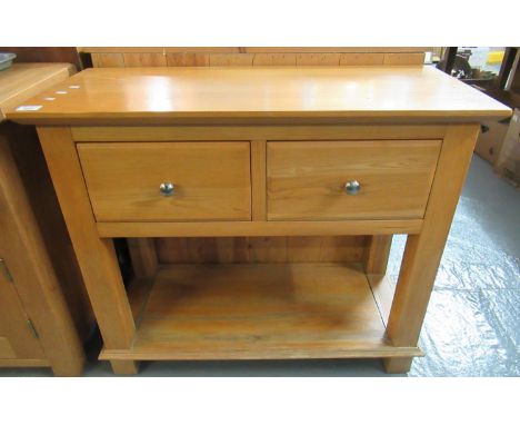 Modern ash side or console table, the moulded top above two drawers with silvered, turned handles and under-shelf, on square 