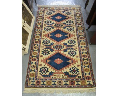 Turkish cream ground runner, overall with multicoloured lozenge and other geometric decoration. 177 x 103cm approx.(B.P. 21% 