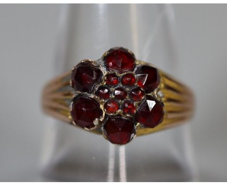 Yellow metal garnet cluster ring.  Ring size Q.  Approx weight 2.8 grams.(B.P. 21% + VAT) 