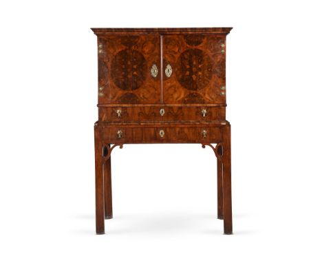 A WILLIAM AND MARY OYSTER VENEERED WALNUT CABINETCIRCA 1690The doors opening to seven drawers around a cupboard, fitted with 