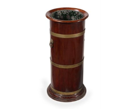 A MAHOGANY AND BRASS BOUND STICK STAND19TH CENTURYWith a metal liner68cm high, 31cm diameter For comparable stick stands see,