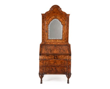 A NORTH ITALIAN FIGURED WALNUT AND CROSSBANDED BUREAU CABINET MID 18TH CENTURY The mirror panel door opening to a divided int