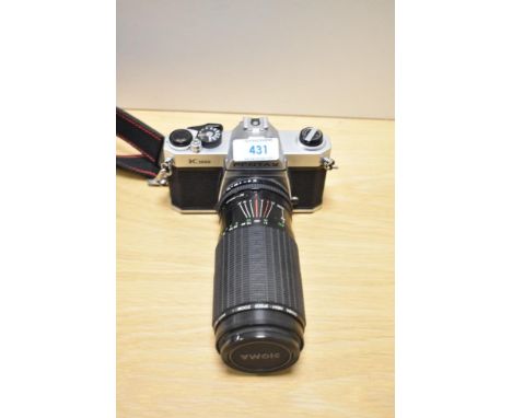 A Pentax K1000 camera No5385153 with Sigma High speed zoom 1:3,5-5,4 f80-200mm lens No505623 in soft camera cover