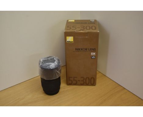 A Nikon Nikkor AF-S DX Nikkor 55-300mm 1:4,5-5,6G ED VR lens for digital camera in original box