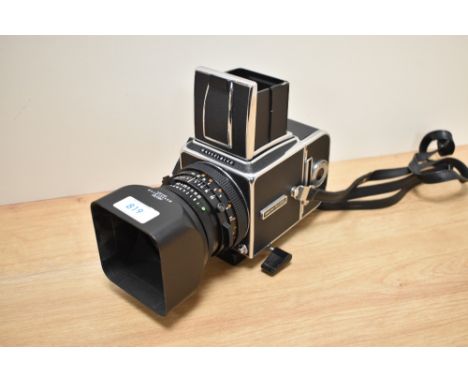 A Hasselblad 500C/M medium format camera with Carl Zeiss Panar 2,8/80 lens, lens hood, having spare A12 film magazine and Has