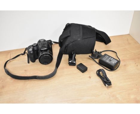 A Panasonic Lumix DMC FZ72 digital camera with charger having Lumix DC Vario 1:2,8-5,9 3.58-215 lens in soft camera case