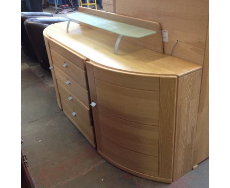 A LIGHTWOOD BOW FRONT SIDEBOARD WITH RAISED GLASS SHELF