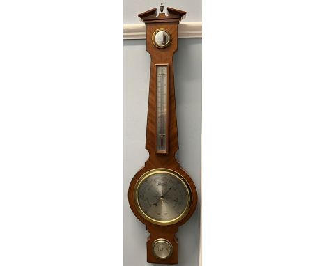 A Comitti of London aneroid barometer, with an alcohol thermometer, silvered dial and hydrometer