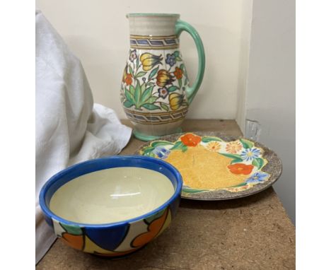 A Charlotte Rhead pottery jug together with a Clarice Cliff plate and a bowl