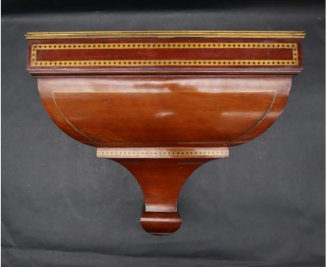 An Edwardian mahogany and brass inlaid clock wall bracket with a rectangular top and caddy shaped base, 39.5cm wide x 33.5cm 