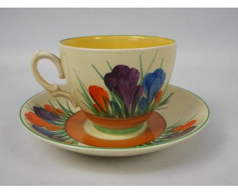 Clarice Cliff - a teacup and saucer hand painted in the Crocus pattern, Clarice Cliff, Royal Staffordshire backstamp, conditi