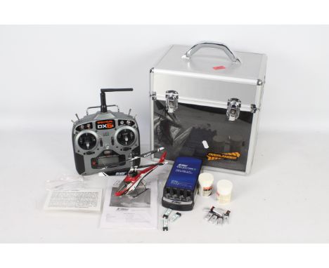 An ultra light blade mcx 2 helicopter with SPEKTRUM DX6i controller and battery charger. In working order with foam lined alu