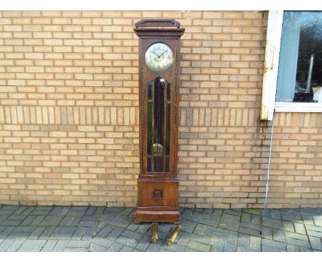 An early 20th century oak cased longcase clock, hour and half past gong striking movement, glazed door with bevelled glass pa